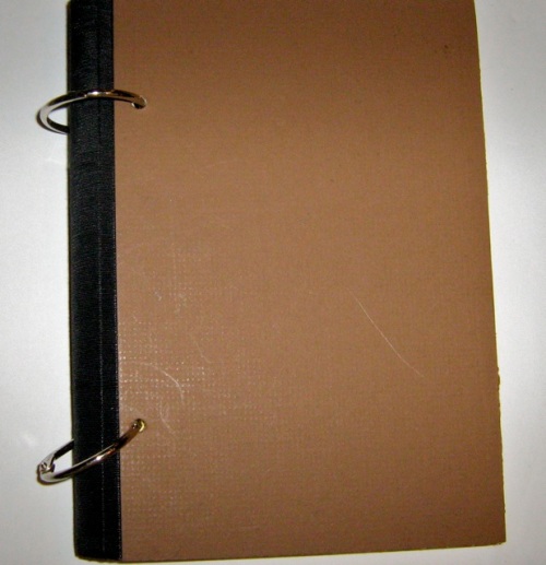 Front cover of brown mat board and black book tape